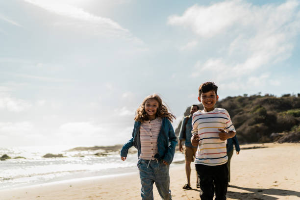 istock Child siblings running on the beach 2151928439
