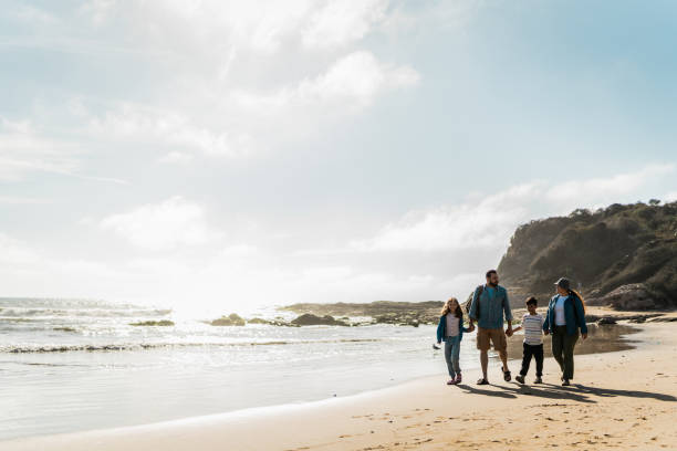 istock Family talking and walking through the beach 2151928457