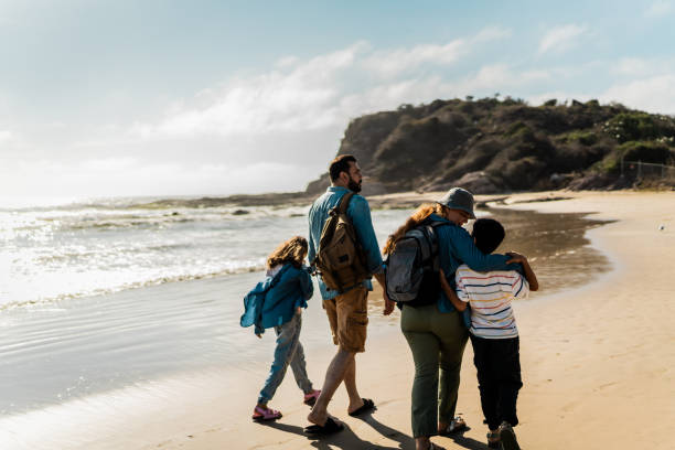 istock Family talking and walking through the beach 2151928576