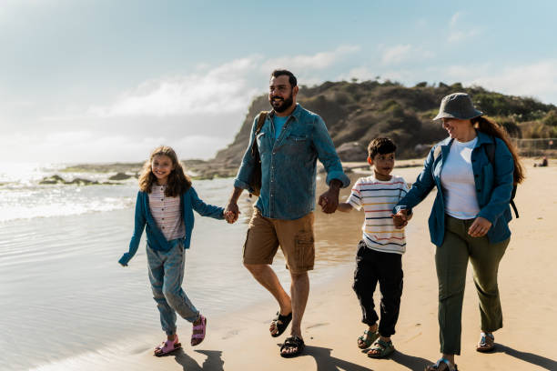 istock Family talking and walking through the beach 2151928582