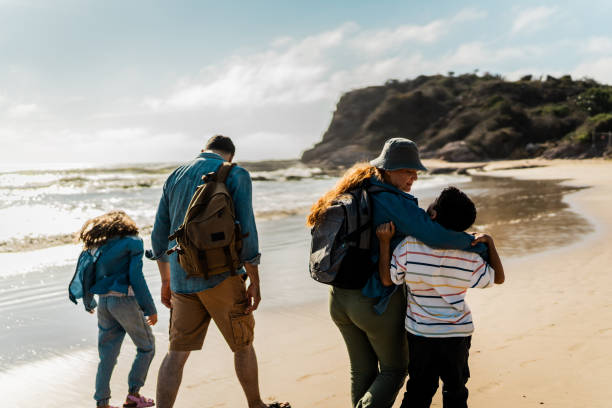 istock Family talking and walking through the beach 2151928588