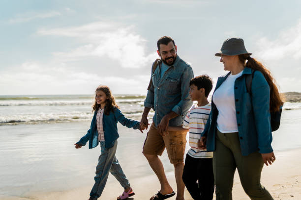 istock Family talking and walking through the beach 2151928589
