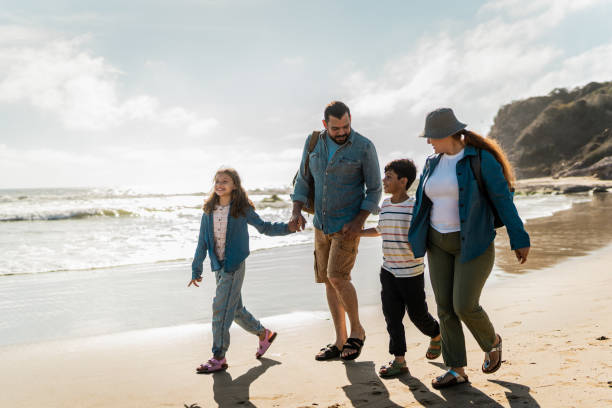 istock Family talking and walking through the beach 2151928596