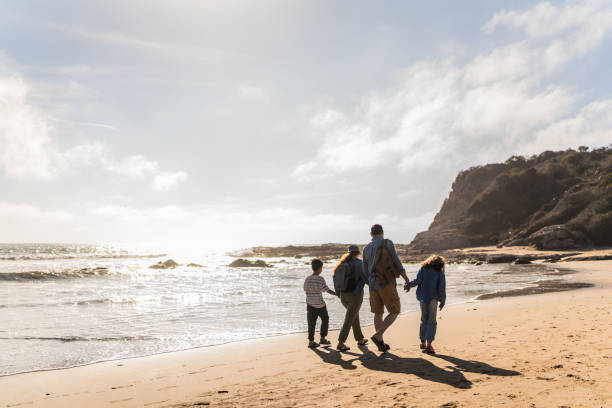 istock Family talking and walking through the beach 2151928622