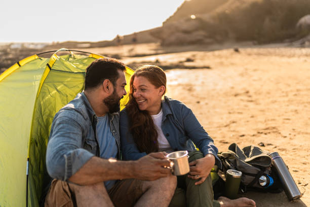 istock Couple talking and camping on the beach 2151929565