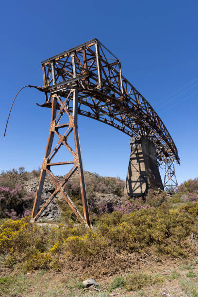 istock Metal structure tower with concrete base from coal mine cable cart industrial abandoned cableway on a spring sunny 2151929783