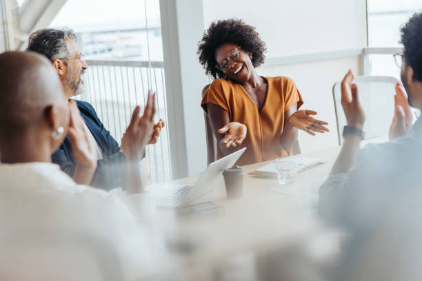 istock Successful business team applauding and celebrating their project in a diverse boardroom meeting 2151930006
