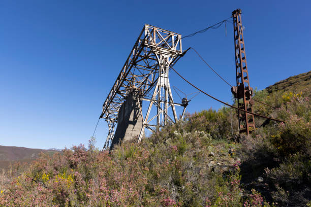 istock Abandoned industrial coal mining steel structure tower from cableway with cable in Tormaleo Asturias province of Spain on a bright day. 2151930389