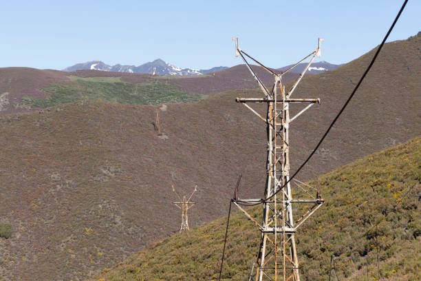 Abandoned industrial coal mining steel structure tower from cableway with cable in Tormaleo Asturias province of Spain on a bright sunny day.
