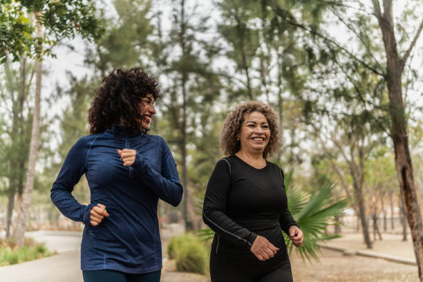 istock Mother and daughter talking and walking through the public park 2151931367