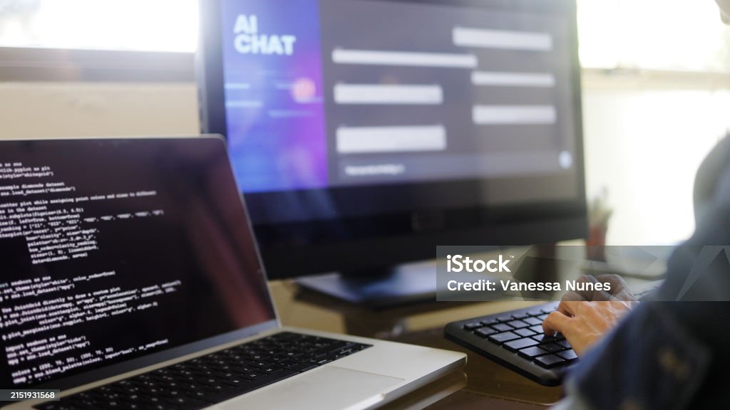AI chatbot: Programmer using artificial intelligence for software development inside office. Virtual chat Bot technology trend Generative AI Model Stock Photo AI chatbot: Programmer using artificial intelligence for software development inside office. Virtual chat Bot technology trend Generative AI Model Stock Photo