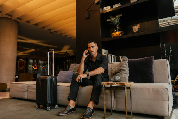 Businessman using smartphone in hotel lounge