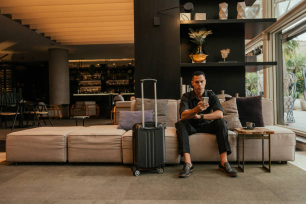 istock Businessman using smartphone in hotel lounge 2151935788