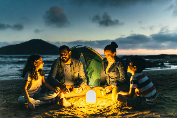 istock Family talking and camping on the beach 2151935899