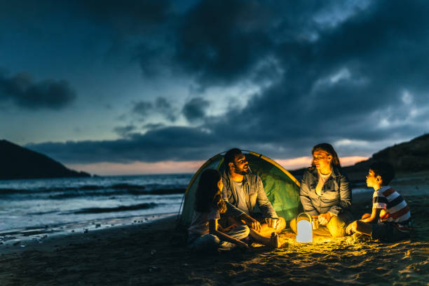 Family talking and camping on the beach