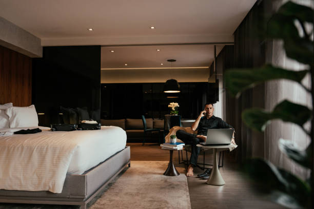 istock Businessman on a call in hotel room 2151936129