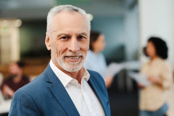 istock Confident, smiling mature man, elderly businessman wearing suit, looking at camera 2151937313