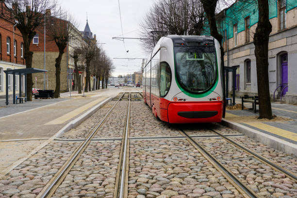 istock A modern low-floor tram car at a newly built stop platform and paved intermediate track surface 2151937662