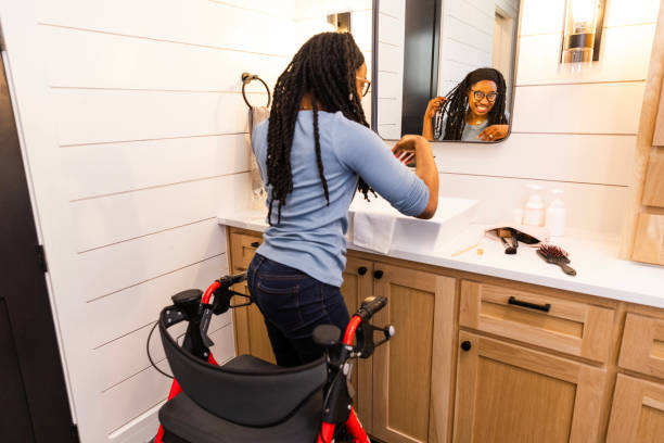 istock Young woman with disability smiles while looking at herself in the bathroom mirror 2151939427