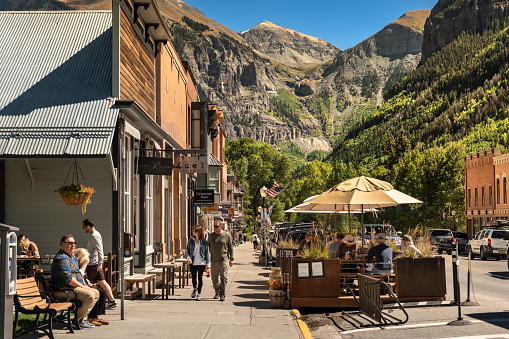 Telluride, Colorado - September 20, 2023:  People and traffic move along the downtown Main Street of the historic old mining town in Telluride Colorado