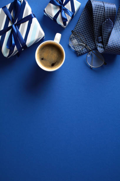 istock Happy Fathers Day vertical banner template. Flat lay vintage gift box, coffee cup, glasses on dark blue background. Top view, overhead. 2151941443