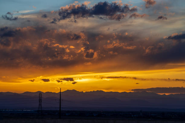 Sunset sky in the spring over the suburban neighborhood in Aurora, Colorado, with a communication tower in the foreground