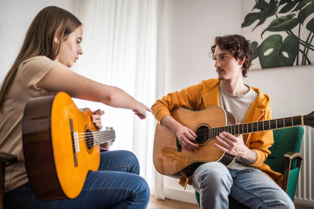 istock Guitar Lesson in Progress with Female Student 2151945710