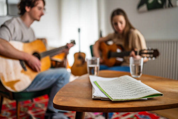 istock Guitar Lesson in Progress with Caucasian Instructor and Female Student 2151945713