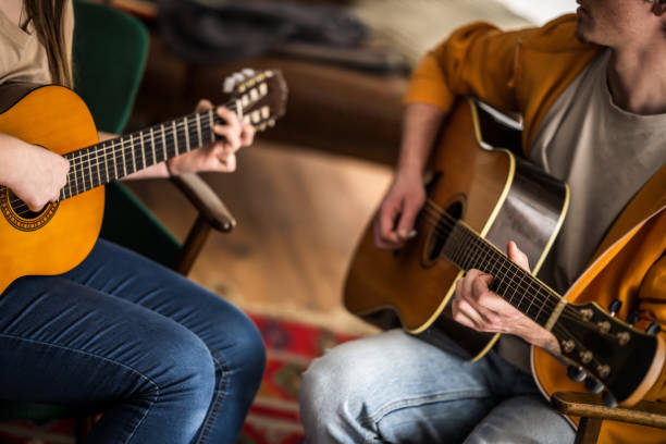 Guitar Instruction Session with Caucasian Tutor and Female Student