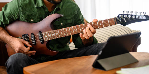 istock Black Guitarist Playing Electric Instrument Indoors 2151945722