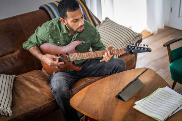 istock Talented Musician Engages with Electric Guitar Indoors 2151945733