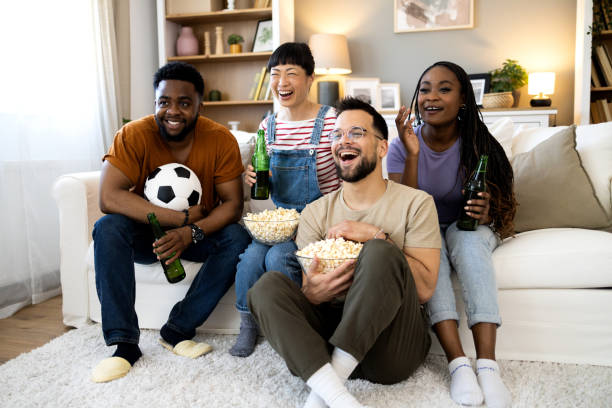 istock Group of ecstatic friends cheering for their team 2151947037