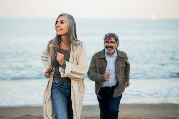 istock Mature couple enjoying jogging on the beach 2151947961