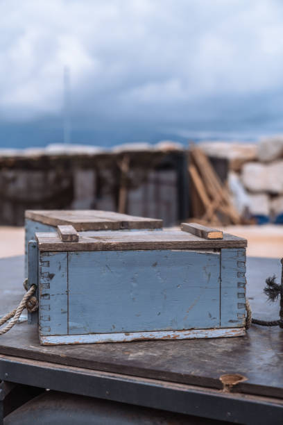 Old wooden crates used for storing army ammunition, showcasing a weathered and rustic appearance.