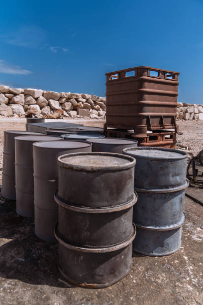Toxic substances. Barrels with danger sign. Symbol of toxic substances on metal barrels. Concept of chemical industry. Production of hazardous toxic products. Yellow black barrels on pallet