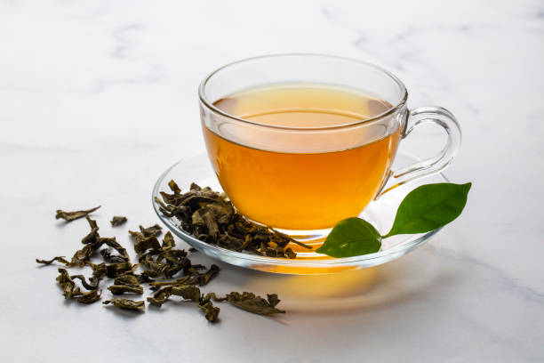 istock Cup of healthy green tea with tea leaves. 2151954155