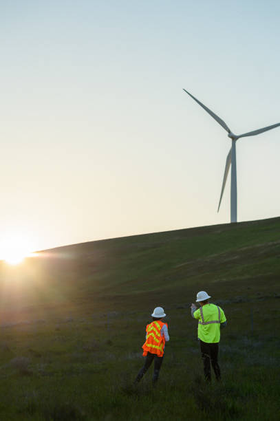 istock Engineers meeting outdoors at wind farm 2151960317