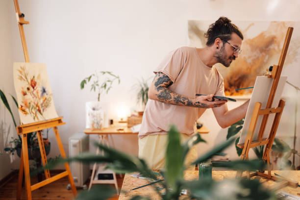 istock Creative hipster painter painting on easel at art studio. 2151960847