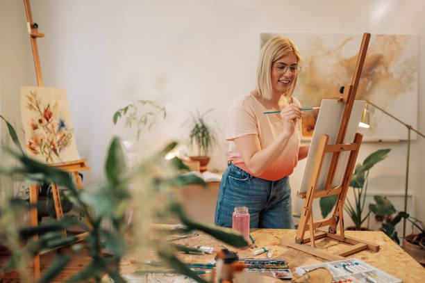 istock Happy inspired artist painting on easel at creative art studio. 2151960862