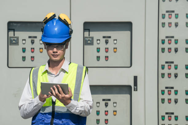 istock Focused young technician in safety gear inspects and controls industrial electrical equipment on a modern facility’s technical room. 2151962056