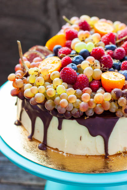 istock Delicious cheesecake with melted chocolate, apples, strawberries, blueberries, peaches, raspberries, blueberries, figs and grape on the top 2151962083