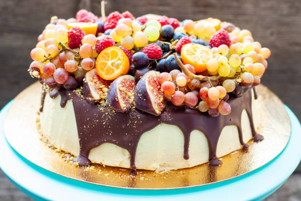Delicious cheesecake with melted chocolate, apples, strawberries, blueberries, peaches, raspberries, blueberries, figs and grape on the top