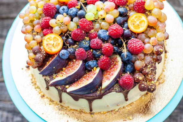 istock Delicious cheesecake with melted chocolate, apples, strawberries, blueberries, peaches, raspberries, blueberries, figs and grape on the top 2151962091