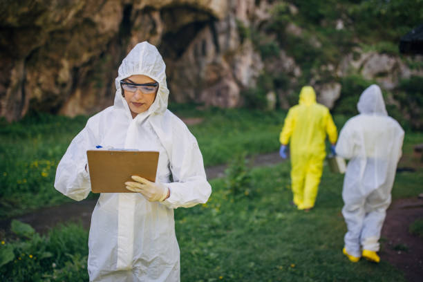istock Environmental scientists conducting field research in protective suits 2151963717