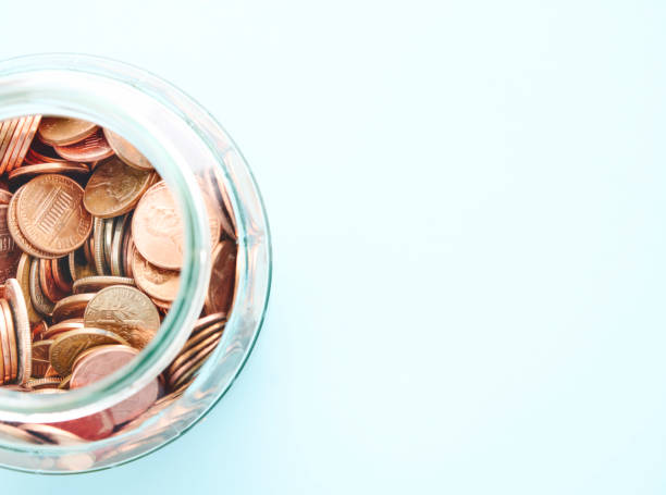 istock American currency in a jar on a blue background with space for text 2151965538