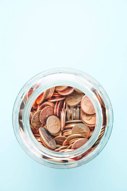 istock American currency in a jar on a blue background with space for text 2151965550