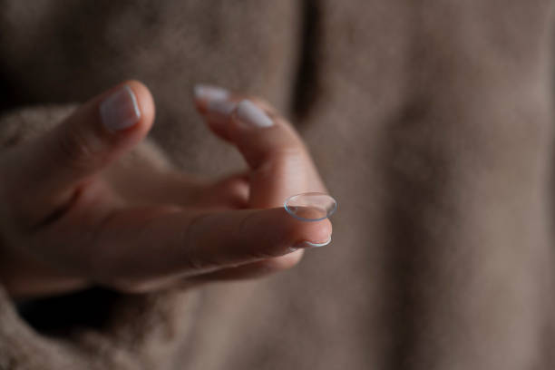 istock Woman holds finger on a contact lens 2151966321