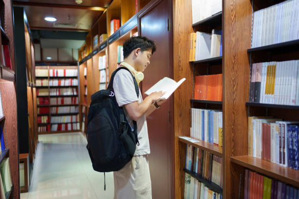istock Man checking books in bookstore 2151969618