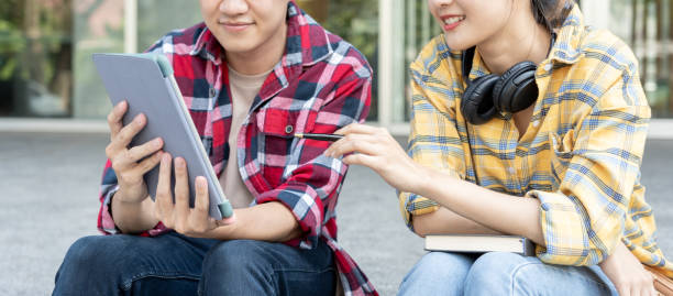 istock Group Asian student meeting team for work project. team happy study online. Read book in college campus. Group on international Asia University. Education, study, school, college, graduation 2151971035
