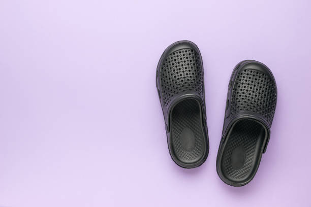 istock Men's rubber flip-flops on a purple background with space to copy. 2151975608
